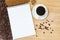 Cup with coffee on the table and notebook