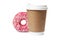 Cup of coffee with tasty donut on white