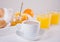 Cup of coffee or tea, bread toast with orange jam, glasses of orange juice on the white background. Breakfast concept