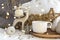 Cup of coffee tea on Christmas composition with candle, deer, fur pillow, and Xmas baubles on New Year background with bright