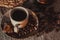 Cup of coffee on textile with beans, dark candy sugar, pots, basket