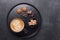 Cup of coffee, various sweets and spice on ceramic plate. Top view. Copy space
