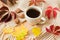 Cup of coffee, warm scarf and scattered autumn leaves on wooden table