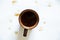 a cup of coffee on a white background and drops of spilled coffee on a white background