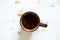 a cup of coffee on a white background and drops of spilled coffee on a white background