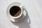 Cup of coffee on white background. Top view, copy space. Morning espresso on table.