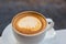 A cup of coffee in white glass,Latte art coffee on table