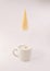 cup of coffee white with an ice cream cone hanging upside down.aesthetic autumn end of summer abstract design