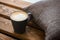 A cup of coffee on a wooden background with a gray pillow, Coffee time