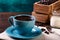 Cup of coffee and wooden containers filled with cofee beans