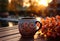 Cup of coffee on a wooden table with autumn leaves in the background