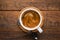 Cup of coffee on wooden table background