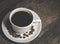 Cup of coffee on wooden table, top view with copyspace