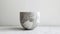 a cup crafted from minerals, set against a pristine white background for a striking contrast.