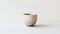 a cup crafted from minerals, set against a pristine white background for a striking contrast.