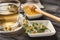 Cup of delicious camomile tea and honey on wooden table, closeup