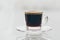 Cup of delicious frothy black espresso coffee