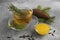 Cup with delicious immunity boosting tea, fir and ingredients on grey table, closeup