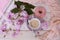 cup with drink coffee cappuccino, hot chocolate with milk, pink donut, scarf, sakura flowers, caffeine improves functioning of