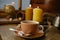 cup with drink coffee on old vintage wooden table, metal coffee maker, candles burn, caffeine improves functioning of human brain