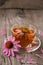 Cup of echinacea tea on old wooden table