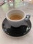 Cup of espresso black saucer marble like table