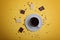 A cup of espresso coffee, pieces and crumbs of dark and white chocolate on a yellow background