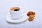 Cup of espresso coffee on white plate with pieces cookie on white background