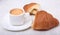 Cup of espresso coffee on white plate with pieces cookie on white background