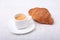 Cup of espresso coffee on white plate with pieces cookie on white background