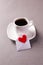 A cup of espresso on a saucer and a love message on Valentine`s Day, a declaration of love