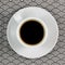 Cup of espresso with saucer on napkin