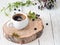 Cup of espresso on a wooden stand in the foreground. Healthy organic foods. Close-up. White vintage wood background. Decorated