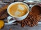 A cup of espresso with yellow autumn leaves, coffee beans.