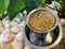 cup of filter coffee with beans decor south Indian special on pebbles leaves