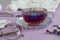 A cup of fragrant tea with lavender branches  glasses for vision against the background of needlework and white yarn  close-up
