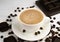 Cup of fresh coffee and and chocolates candies on a wooden table. Close-up. Selective focus