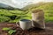 Cup of fresh coffee and roasted beans in a bag on the table against the backdrop of a landscape of coffee plantations