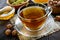 A cup of fresh fragrant herbal tea with honey and hazelnuts on a dark wooden background.