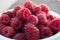 Cup fresh ripe juicy natural raspberry gathered in the garden of