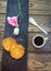 Cup of freshly brewed coffee, sesame cookies, pink lisianthus flower