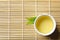 Cup of freshly brewed oolong tea on bamboo mat