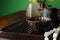 Cup with freshly brewed pu-erh tea and prayer beads on wooden tray, closeup. Space for text