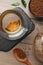 Cup of freshly made aromatic buckwheat tea and granules on wooden table, flat lay