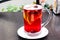 Cup of fruit and berries hot drink in clear glass and cinnamon