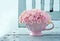 Cup full of pink hydrangea on vintage chair