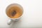 A cup of green tea with tea bag on a white background