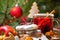 Cup of grog, Christmas cookies, fruit and spices, closeup with selective focus on the background of the Christmas tree