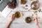 Cup of healthy tea, honey, healing herbs, herbal tea assortment and berries on table. Top view. Herbal medicine.