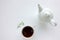 Cup of herbal oregano tea with dry marjoram flowers on white table background with copy space.